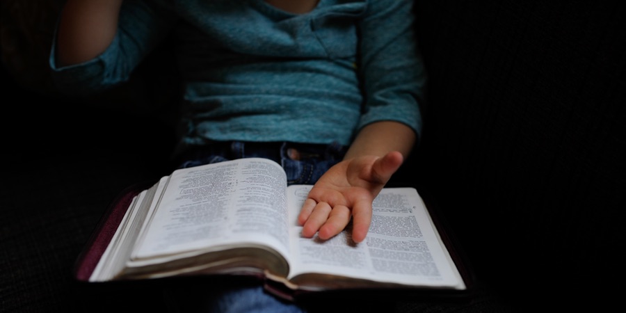 lady with bible and open hand